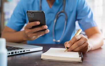 Doctor with phone and notepad