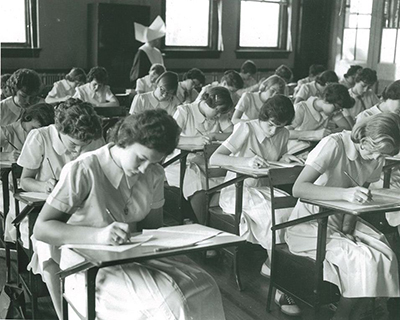 Image of students from the 1960s taking a test in a classroom