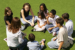 Kids in a circle with afterschool counselor