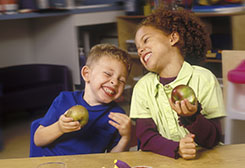 Preschool kids eating apples