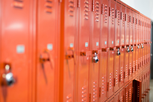 Image of bright orange lockers in a school hallway