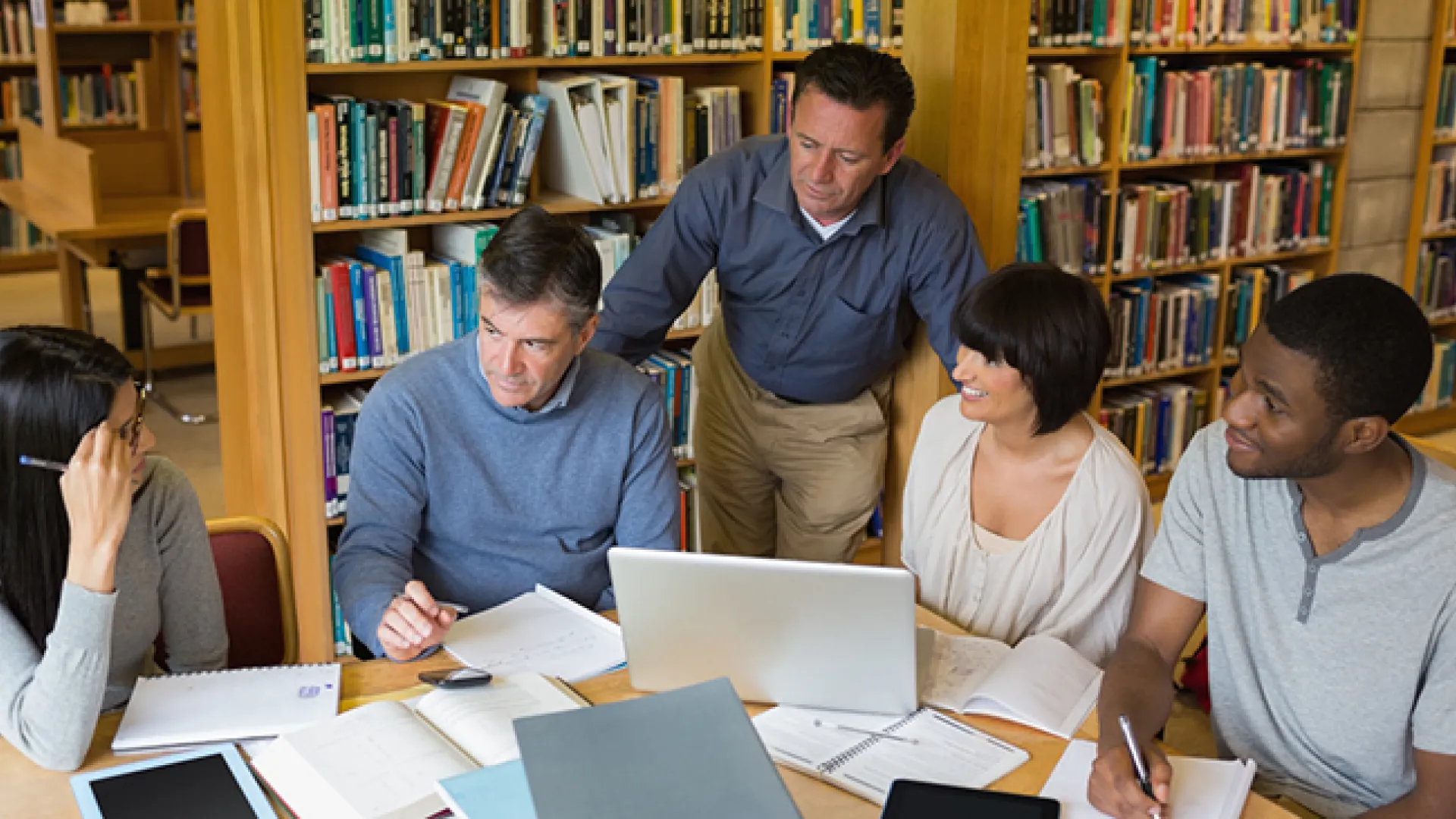 Adults working together in a library