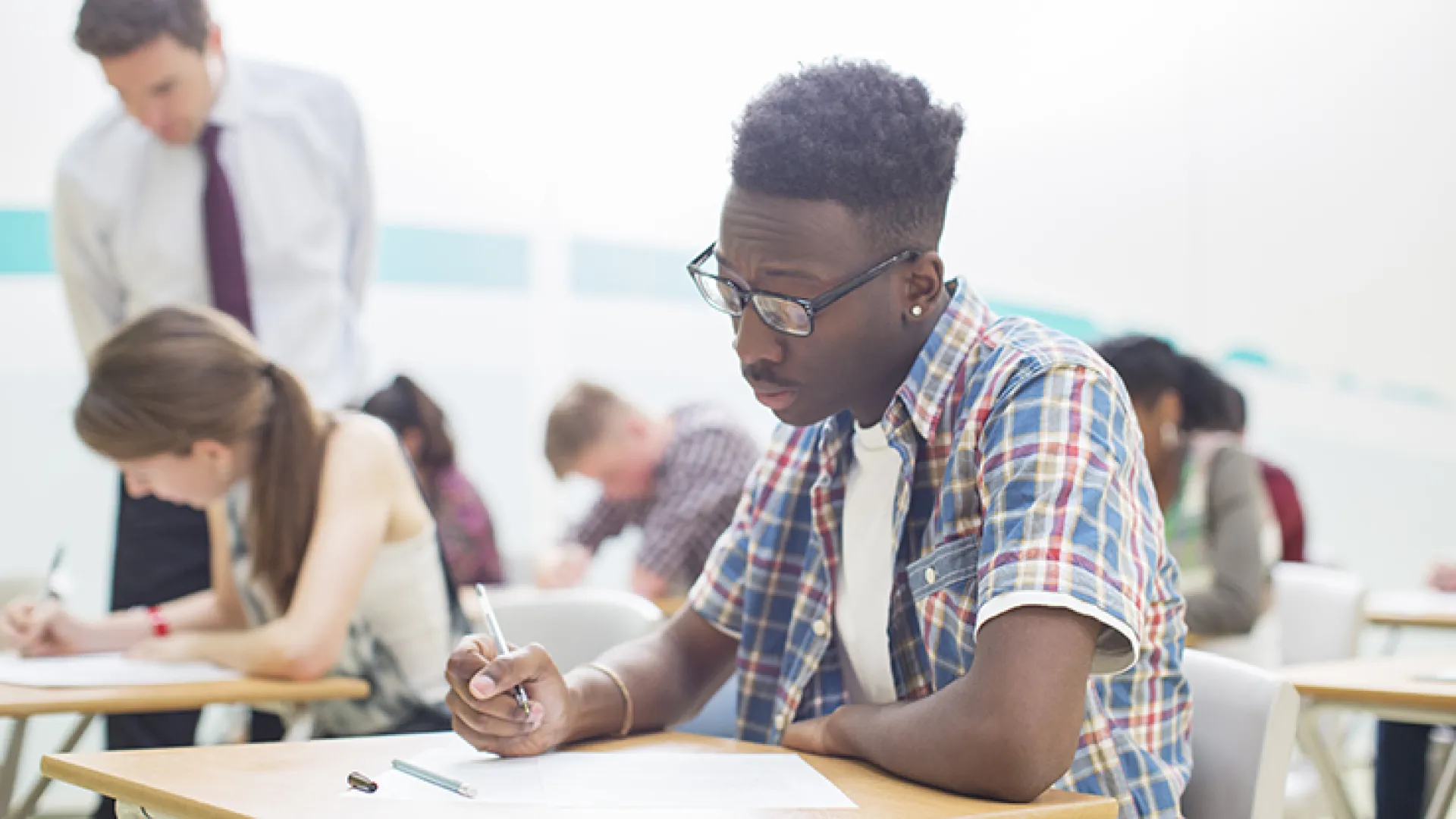 High school student studying at school desk