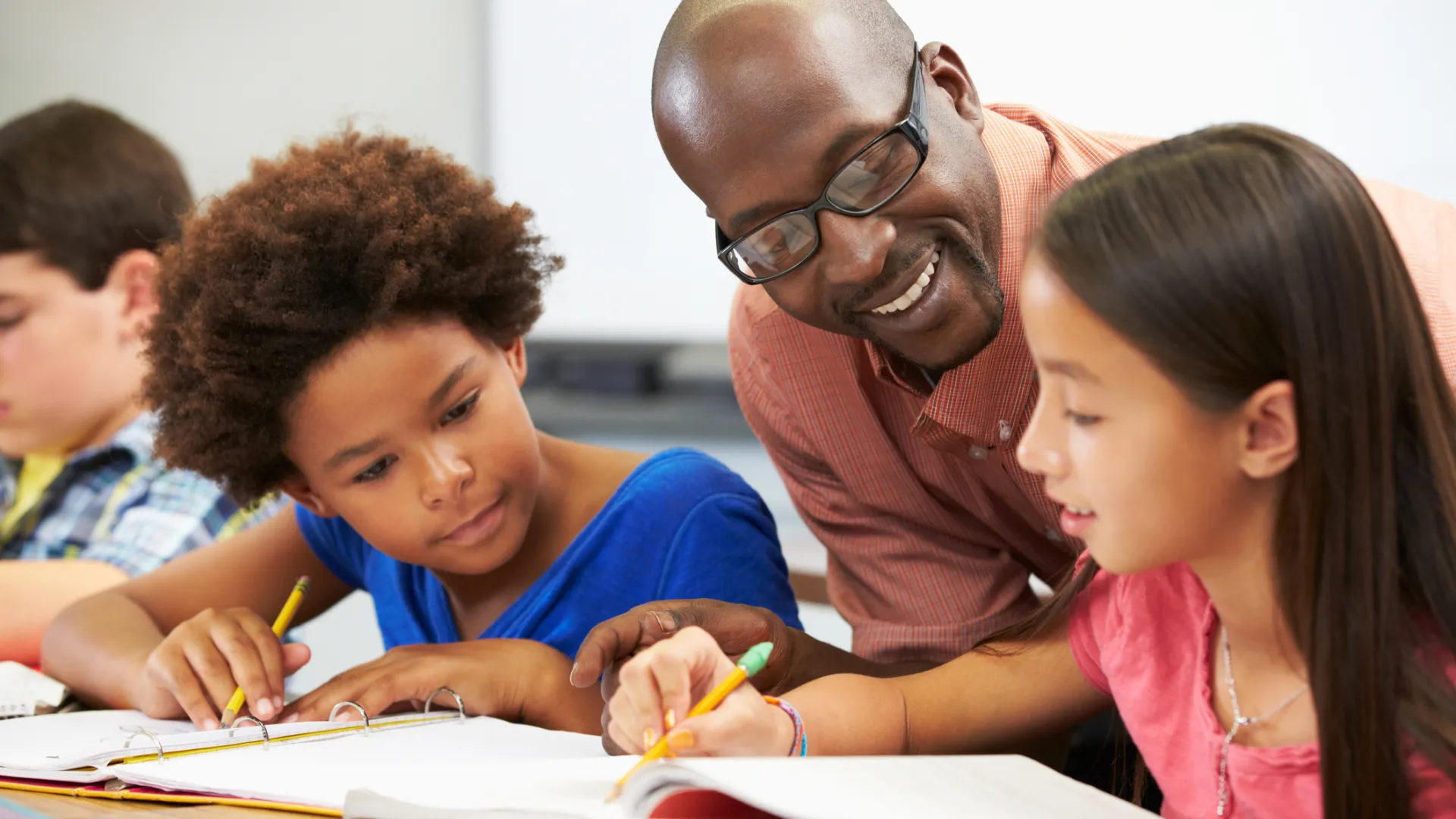 Teacher helping pupils study