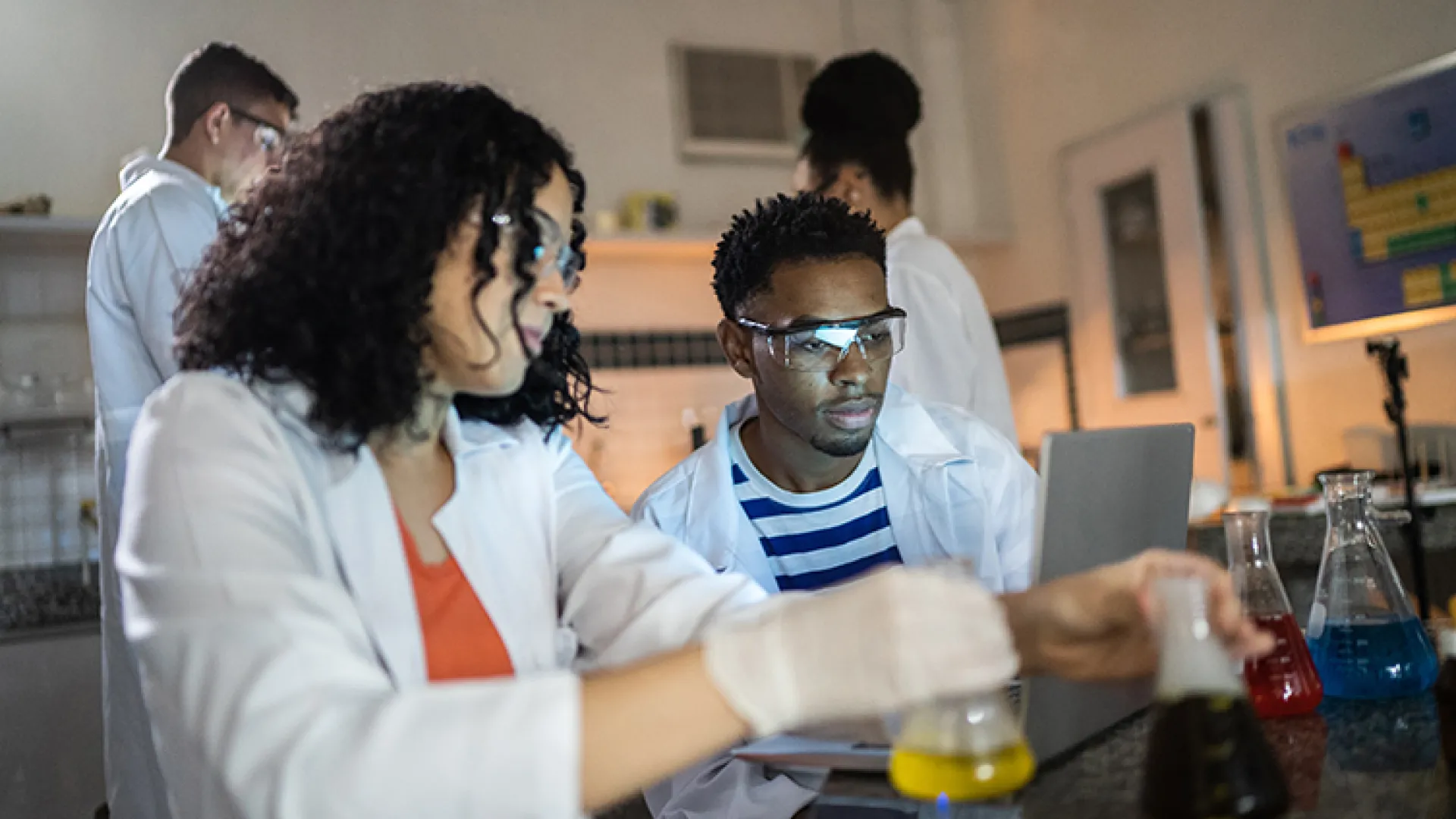 High school students performing a chemistry experiment
