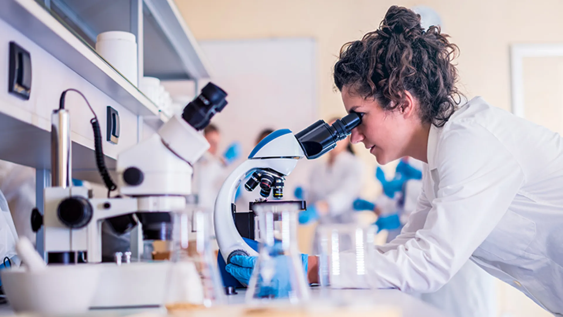 Female scientist at microscope