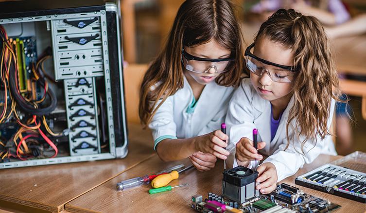 Two young girls working on a STEM project