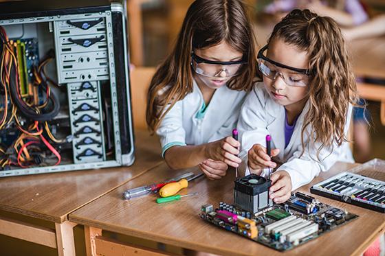 Two young girls working together on a STEM project