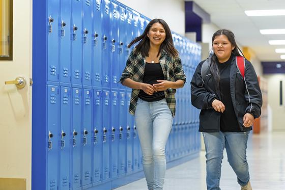 High school students walking down school hallway