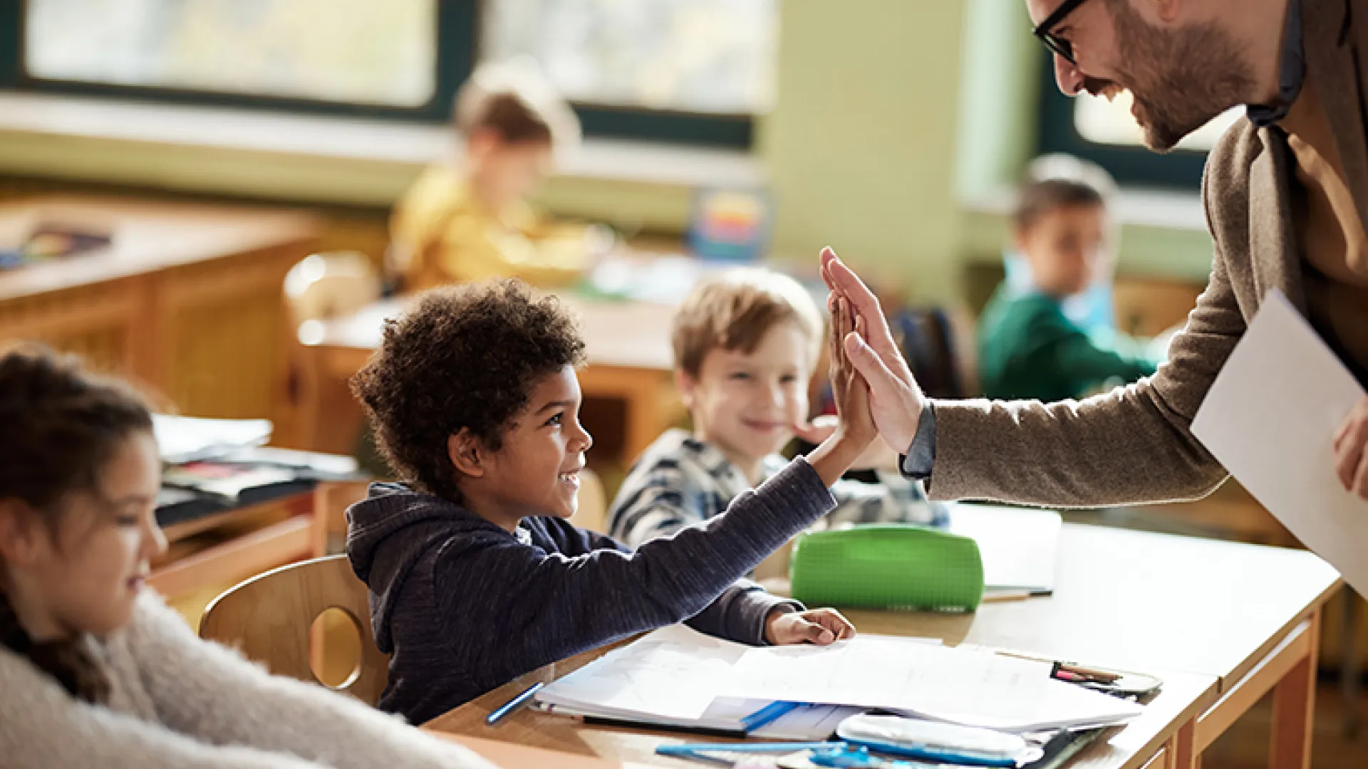 Teacher and student high-fiving