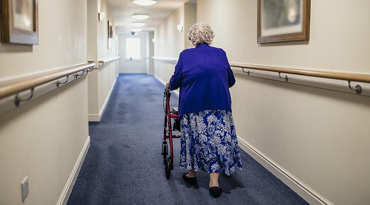 Woman with walker in nursing home