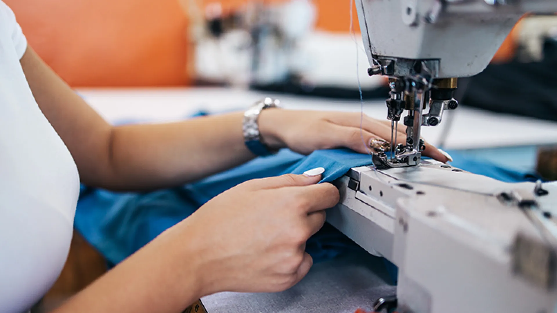 Woman's hands working at a sewing machine