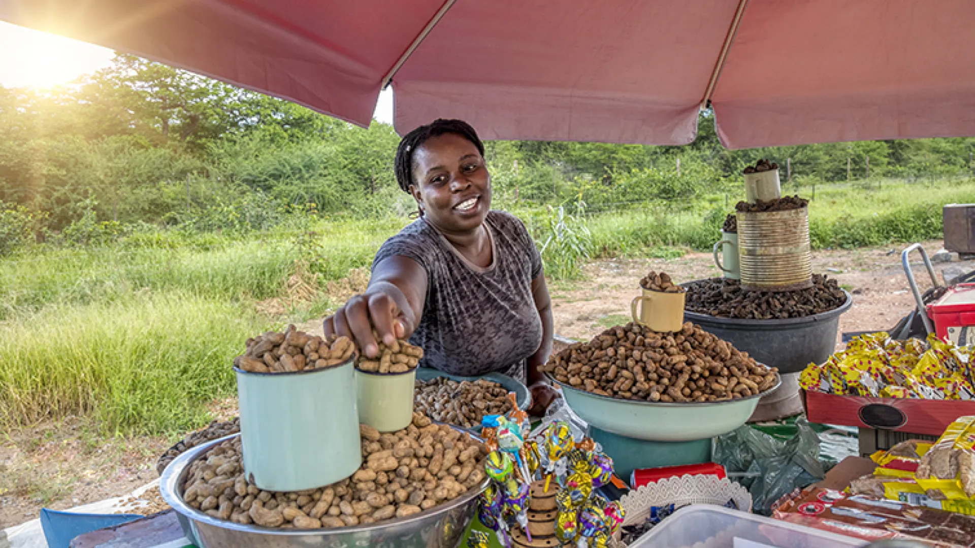 African woman selling peanuts in outdoor market