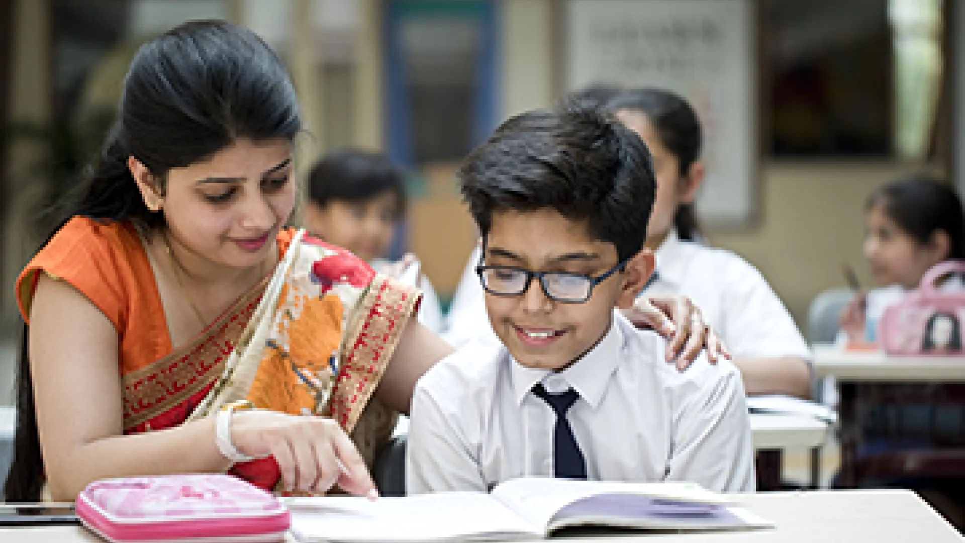 Indian teacher with young male student
