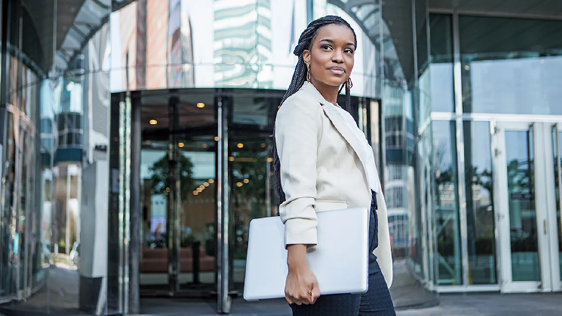 Young business woman outside office building