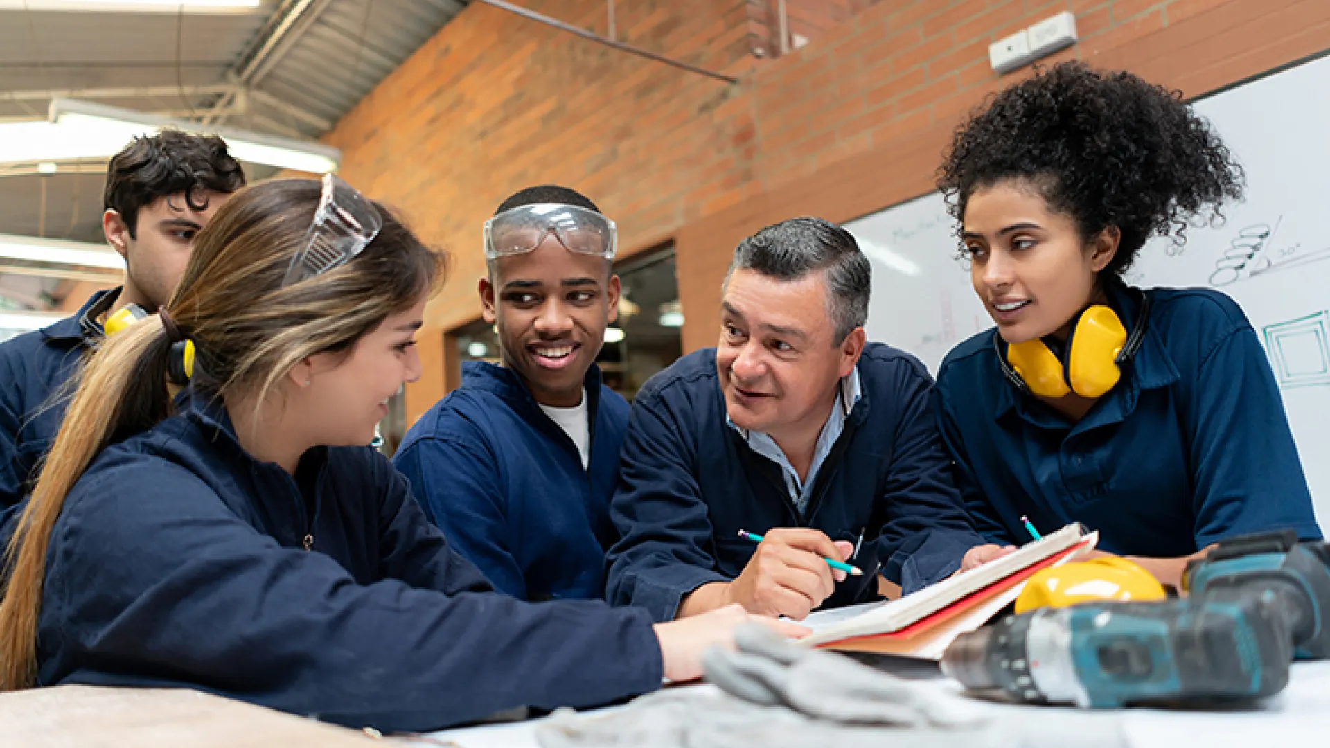 Mentor with apprentices in workshop