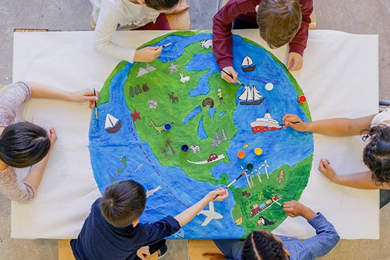Young children painting world map