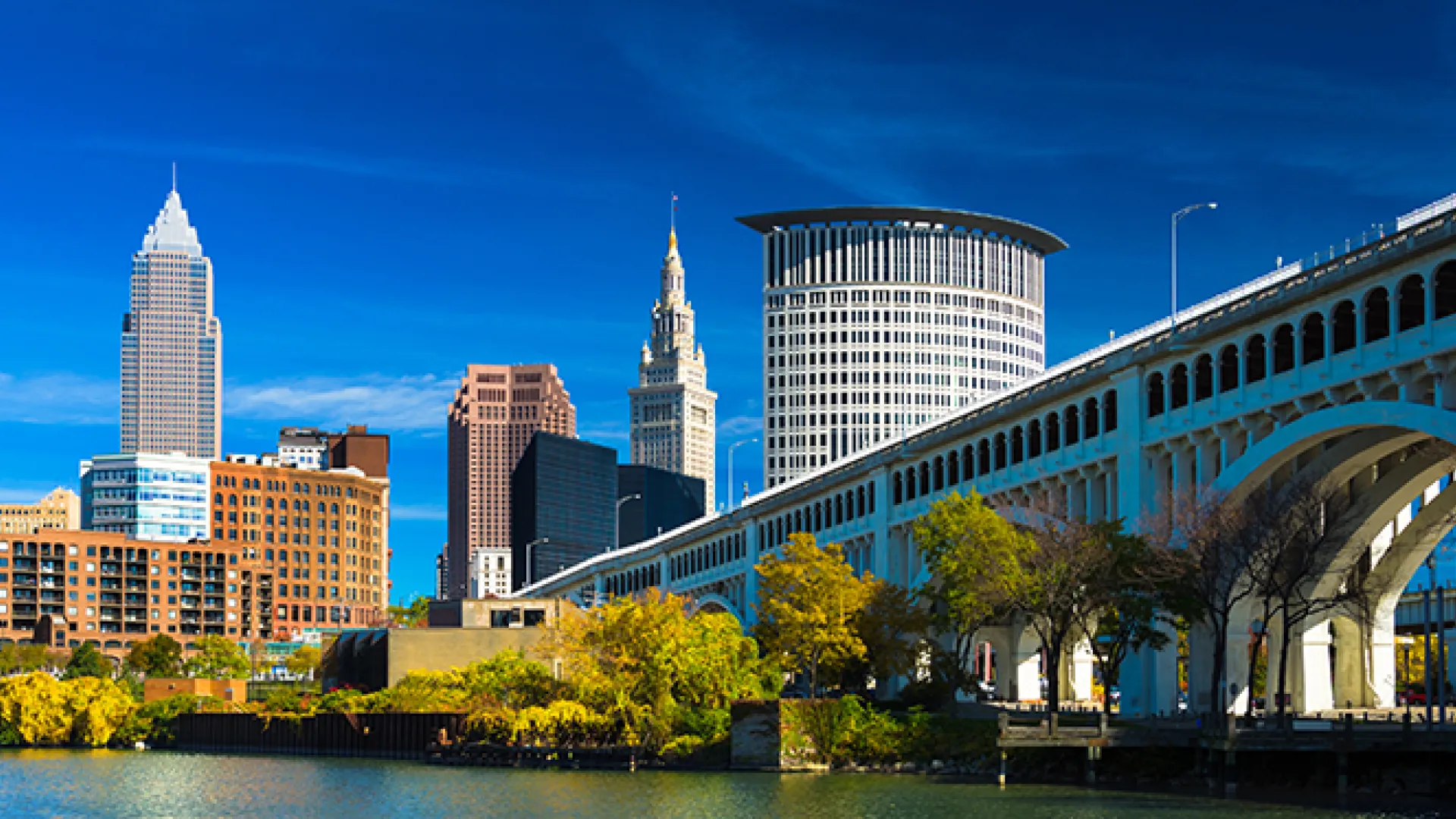 Downtown Cleveland with River, Bridge, Trees, and Deep Blue Sky 