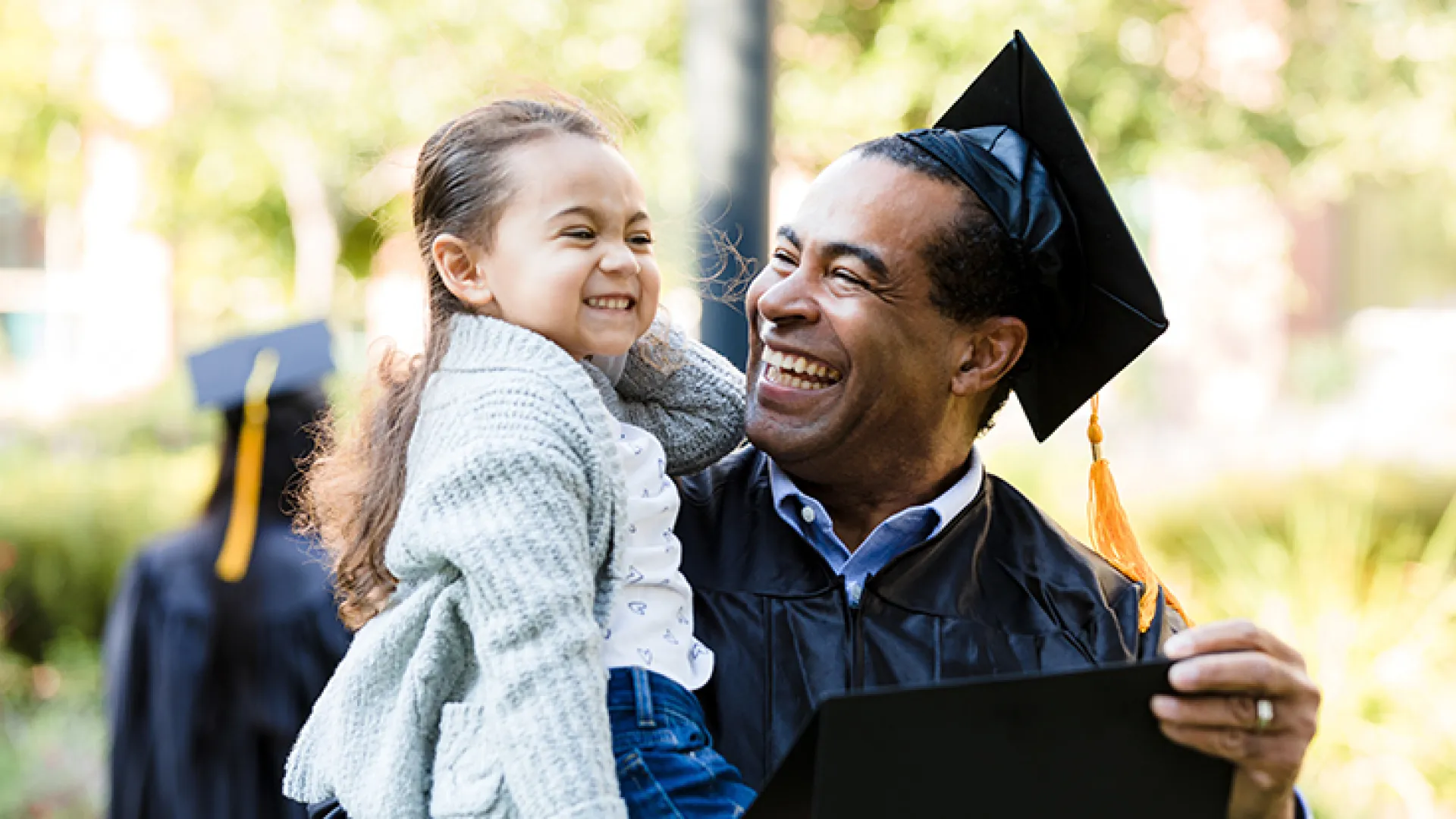 Little girl with graduating grandfather