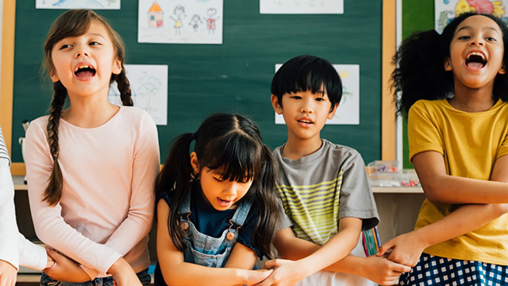 Portrait of school children smiling in classroom