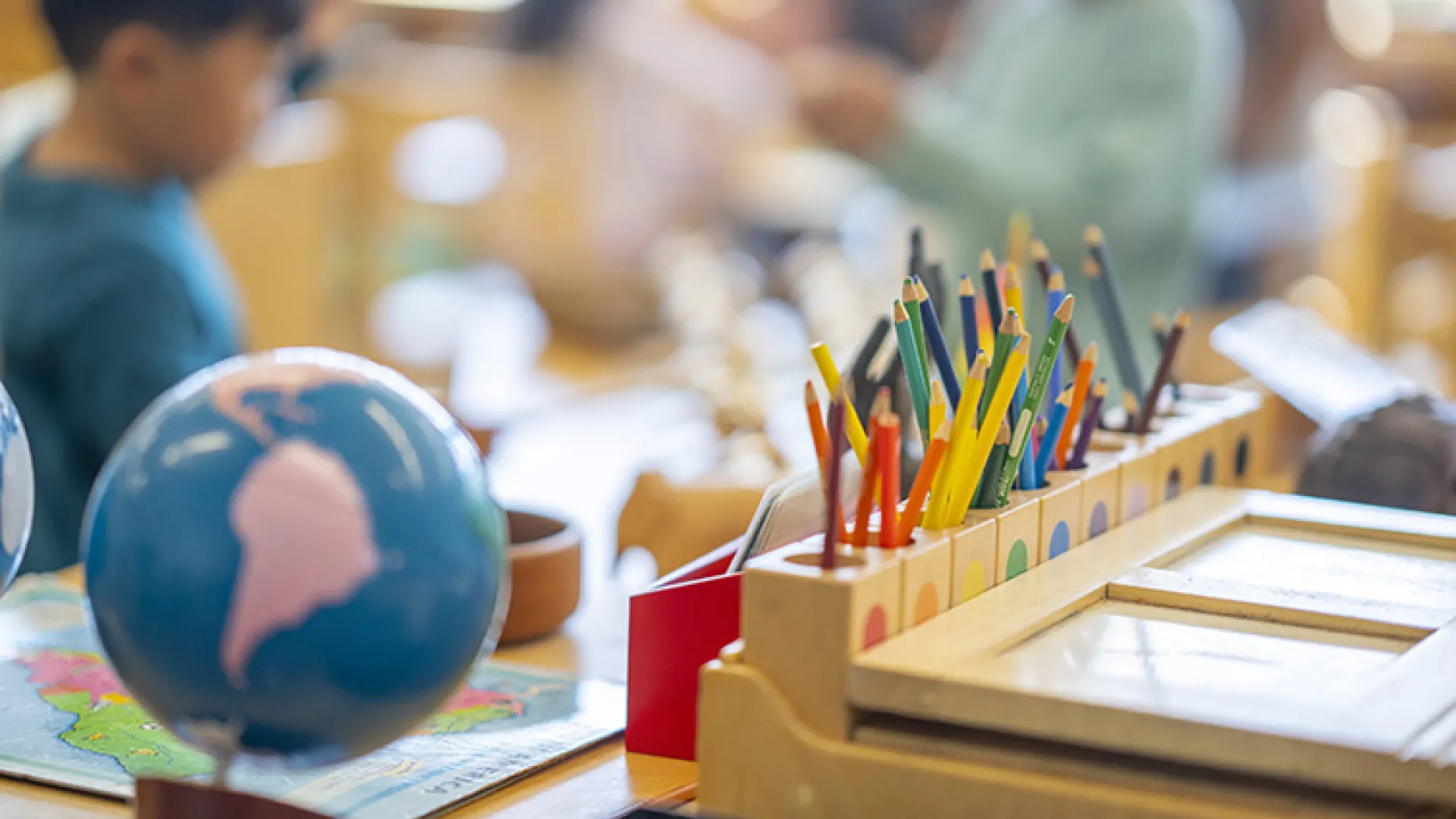 Social studies classroom showing a globe and colored pencils