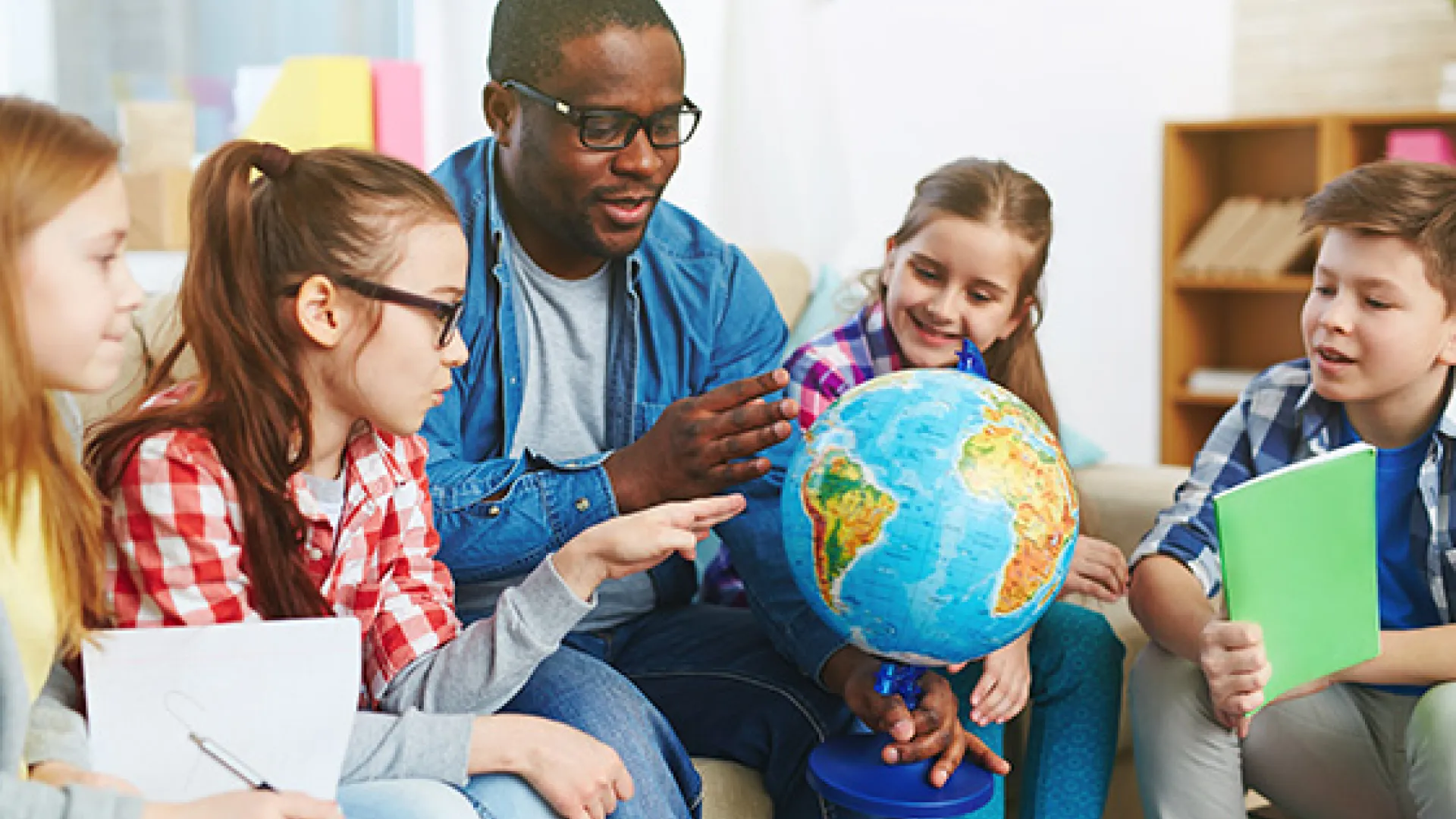 Teacher with students and globe