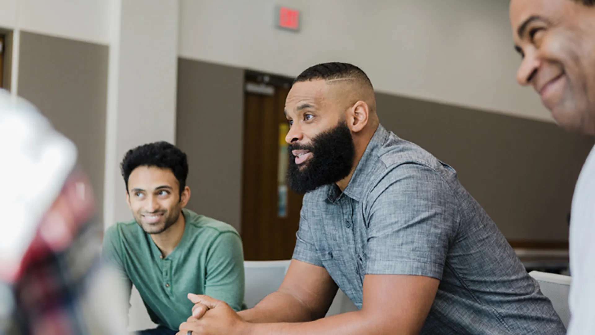 men talking in group therapy