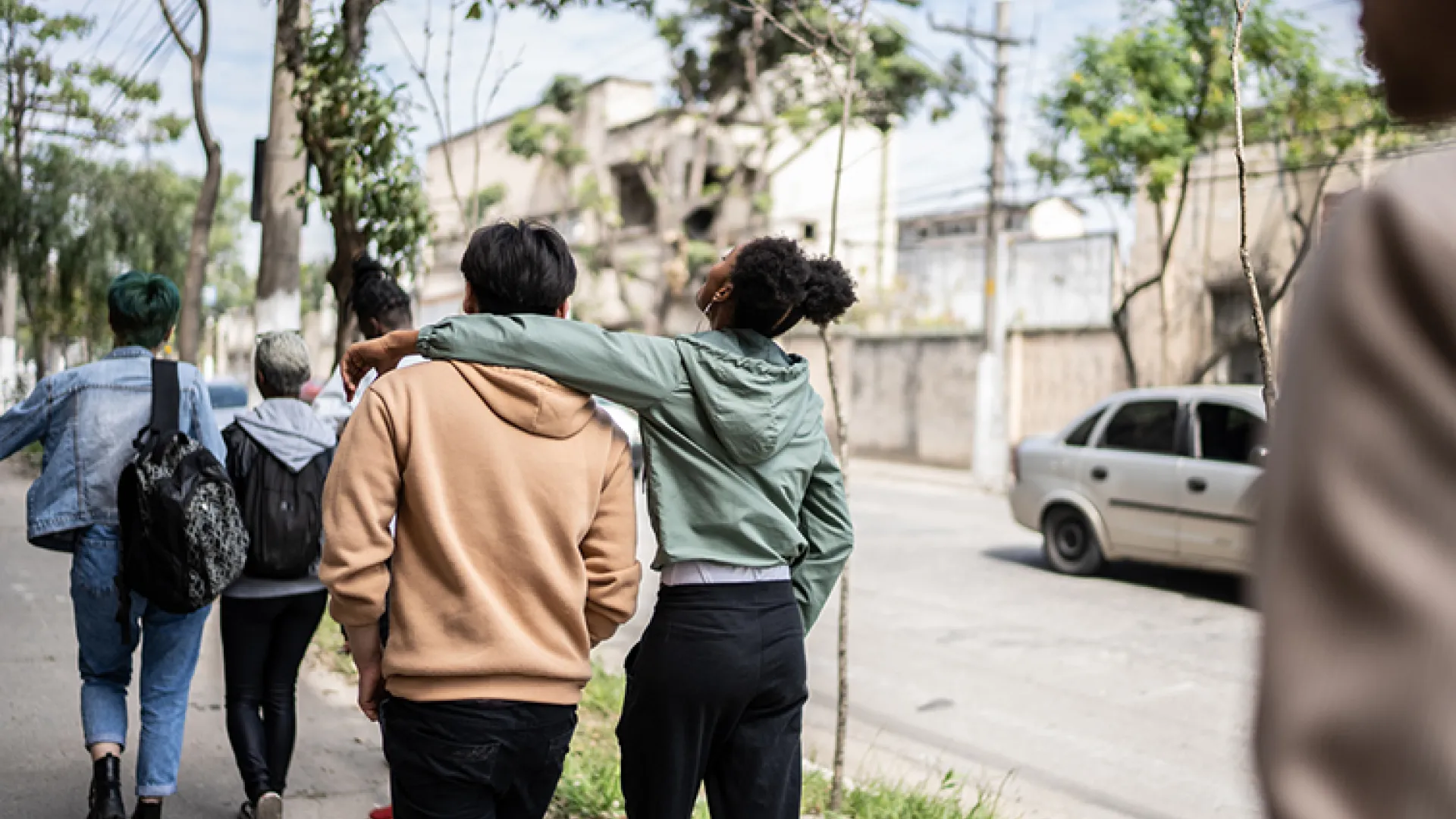 teens walking and talking in street