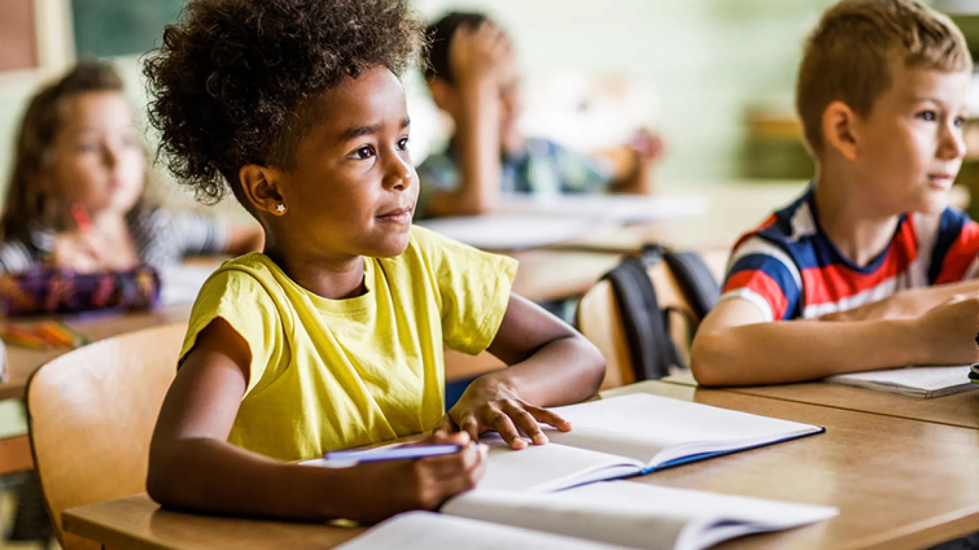 Young girl listening in the classroom