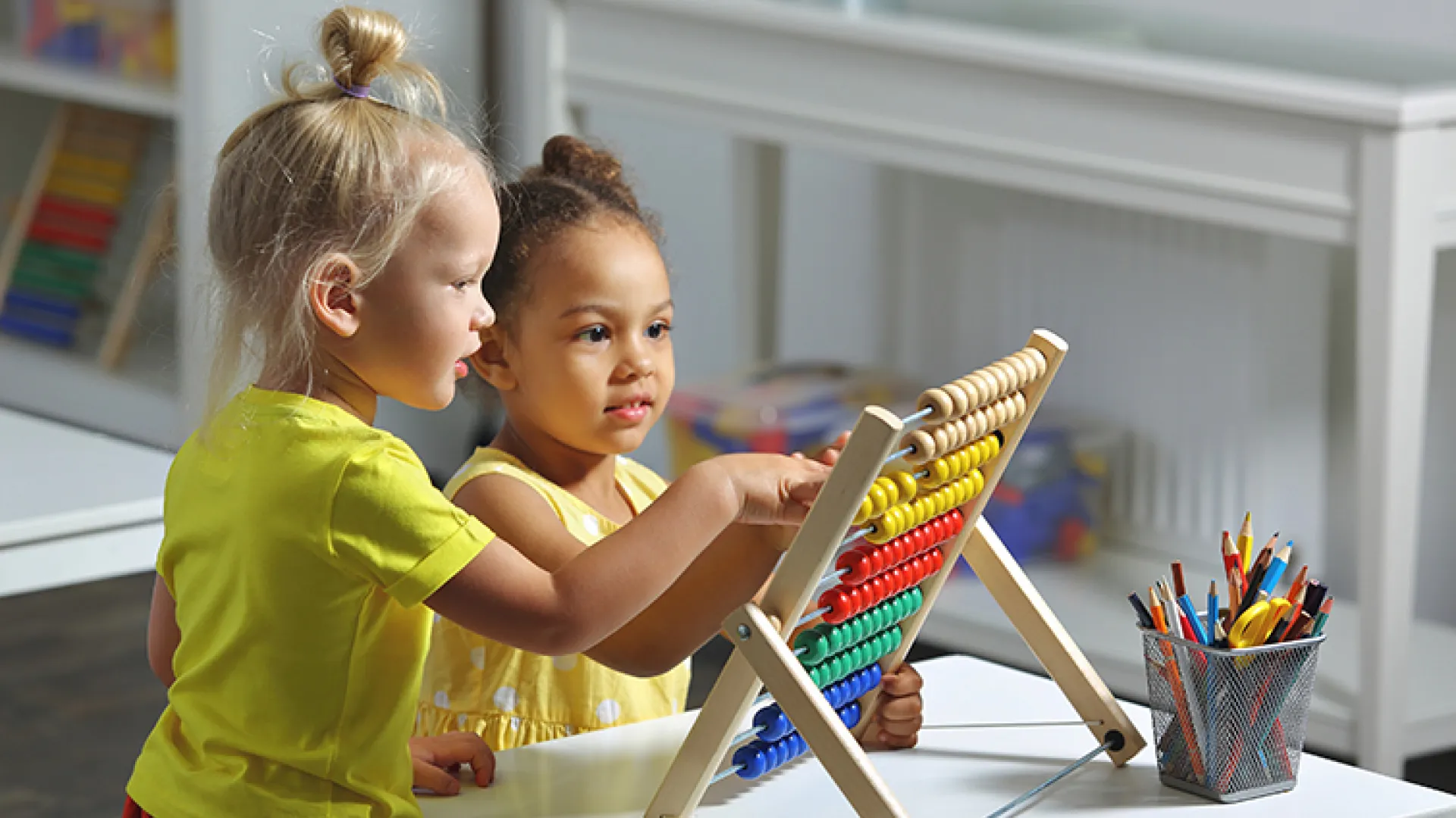 Preschoolers playing with a toy together