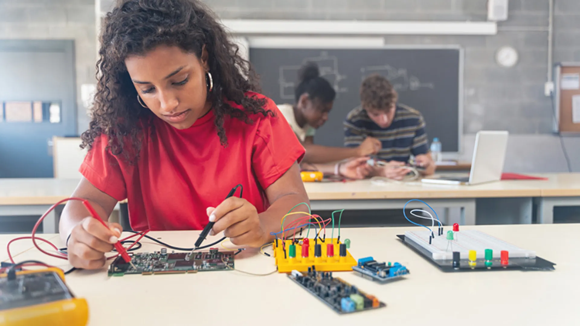 female high school student working on robotics project