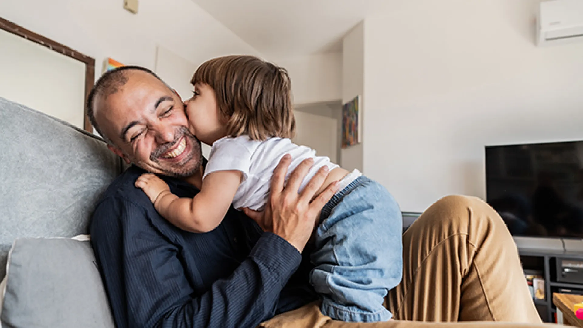 Dad and daughter laughing at home