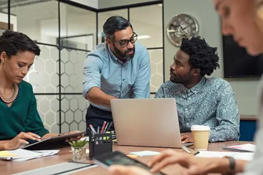 Colleagues discussing work in an office