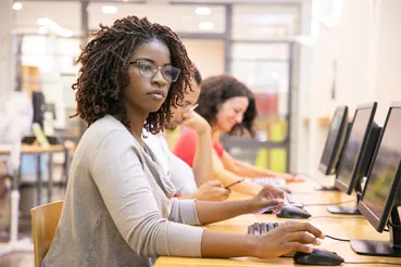 Young woman at row of computers