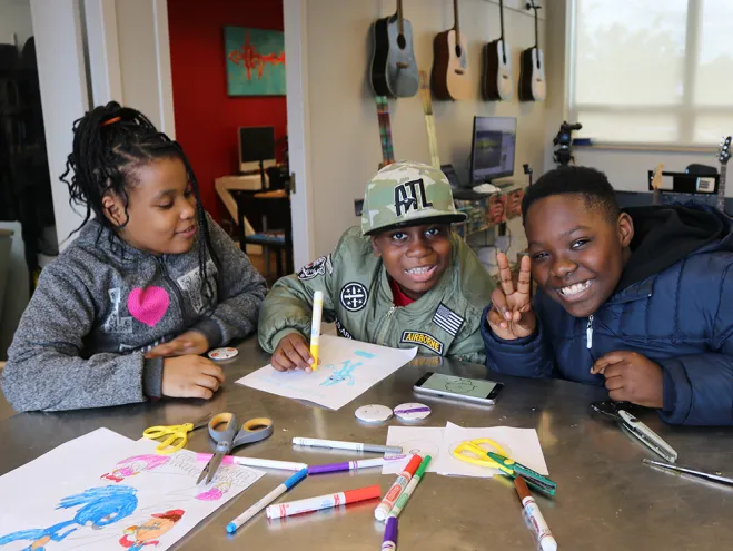 Three young teens doing crafts