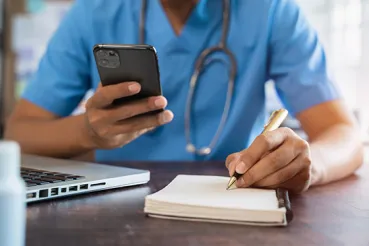 Doctor with phone and notepad
