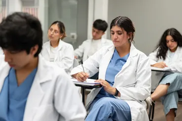 medical student taking notes in class