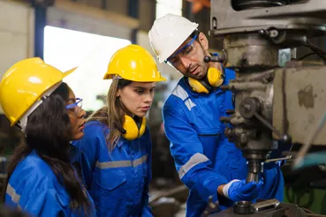 Factory worker with apprentices