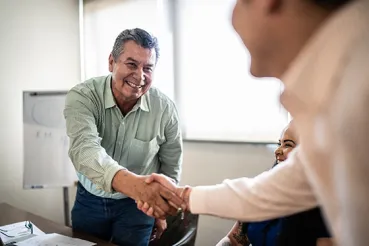 man shaking hands at job interview