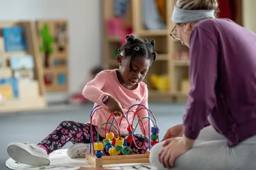 Kindergartner playing with teacher