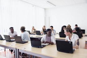 Adult students on laptops
