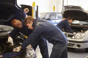Apprentice working with mechanic