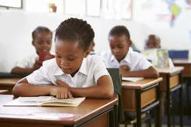 African child reading in a classroom
