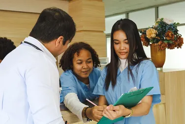 Healthcare trainee with coworkers