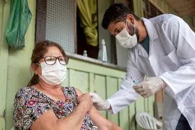 doctor giving shot to woman in rural setting