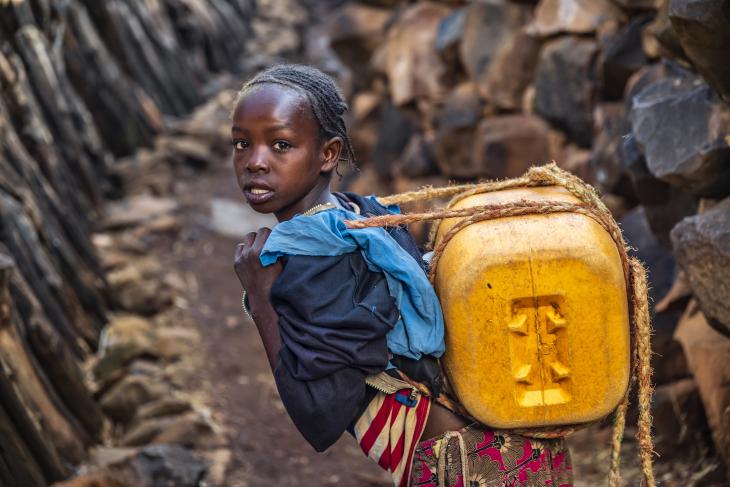 African girl carrying water from the well, Ethiopia, Africa