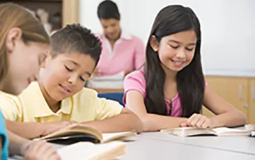 Image of boy and girl reading in classroom