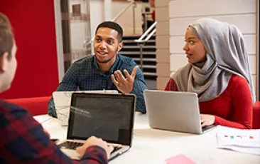 Image of two students working together at a table 