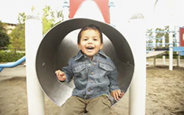 Image of smiling young Native American boy in tunnel