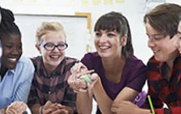 Image of teacher with middle school students